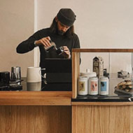 Barista preparing a latte art coffee drink