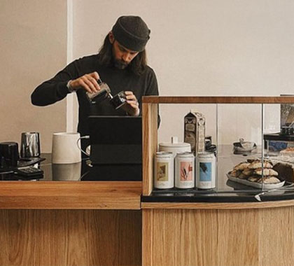 Barista preparing a latte art coffee drink